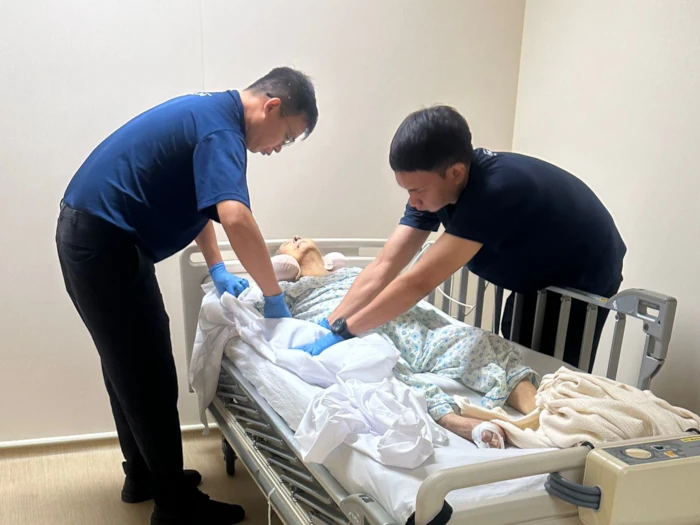 Singapore Funeral Enterprise Team Singapore Funeral Enterprise team preparing deceased's body for transport to site of funeral wake